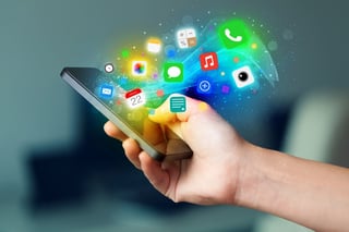 Hand holding smartphone with colorful app icons concept.jpeg